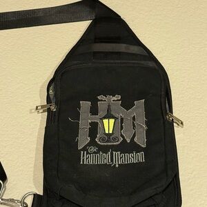 Disney Black Haunted Mansion Sling Backpack with Yellow Lantern